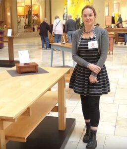 Minnesota Woodworker Guild member standing by her work.